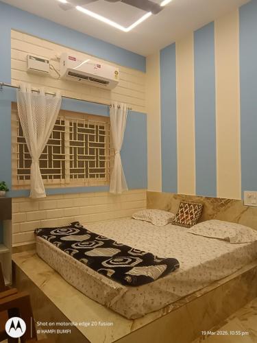 a bedroom with a large bed in a room at Smarami homestay in Hospet