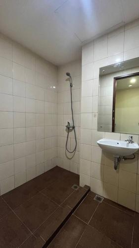 a bathroom with a shower and a sink at Vida View Apartment by Vida Connect in Makassar