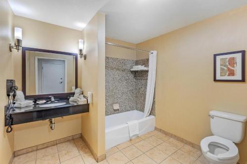 a bathroom with a toilet and a sink and a shower at Comfort Suites Blythe in Blythe