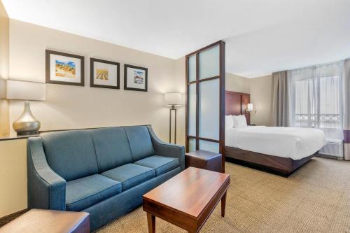 a hotel room with a couch and a bed at Comfort Suites Blythe in Blythe