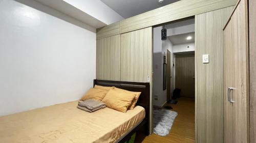 a small bedroom with a bed and a hallway at Netflix & Chill at Pablo's Homestay-Grace Residences Tower 4 in Manila