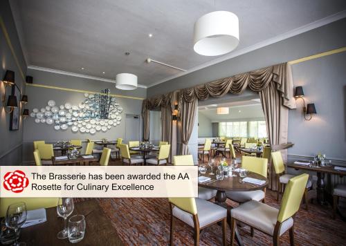a restaurant with yellow chairs and tables and a sign that reads the baskinake at Mercure Bristol North The Grange Hotel in Bristol