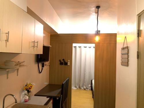 a kitchen with a door leading to a dining room at Netflix & Chill at Pablo's Homestay-Grace Residences Tower 4 in Manila