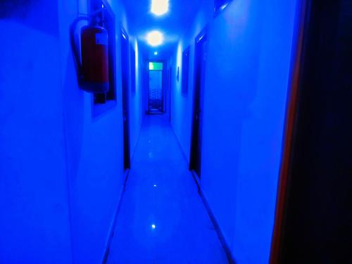 a hallway with blue lights in a room at Hotel shyama inn in Lucknow