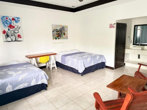 a room with two beds and a table and a desk at Casa villa del mar 2 in Miramar