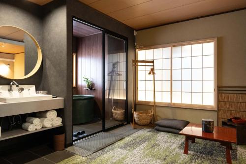 a bathroom with a sink and a shower at Ryokan Suzuri 旅館 すずり in Tokyo
