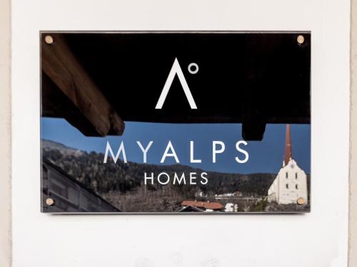 a sign for myleys homes with a picture of a church at MYALPS Historical in Oetz