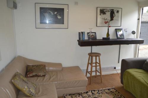 a living room with a couch and a table at Crockers Farm in Dorking