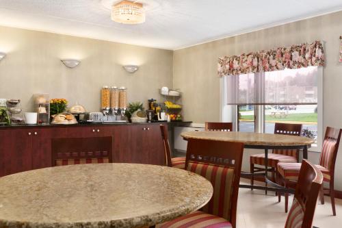 a dining room table and chairs in a kitchen at Travelodge by Wyndham Owen Sound ON in Owen Sound