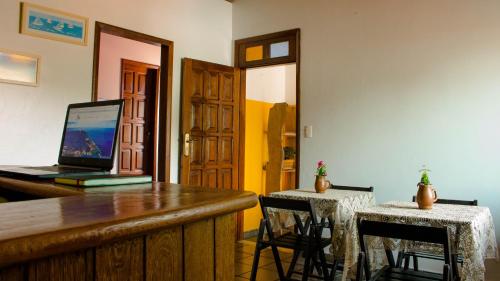 a room with a bar with a laptop on a desk at Pousada Morro Bello in Morro de São Paulo