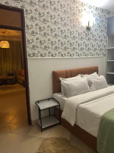 a bedroom with a bed and a side table at Serene Sidai in Nairobi