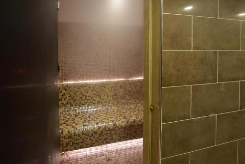 a bathroom with a shower with a glass door at Dogramaci Hotel City in Tosya