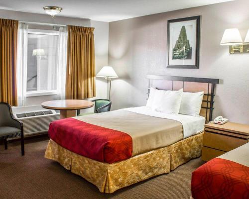 a hotel room with a bed and a table at Econo Lodge Inn & Suites Colonie Center Mall in Albany