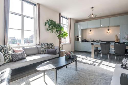 a living room with a couch and a table at The Carriage House - Historic 3-Bedroom Apartment in Vianen near Utrecht - Huize de Lekpoort in Vianen