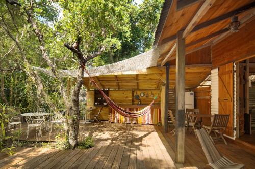 a hammock on the deck of a cabin at Esprit Caraibe in Saint-François