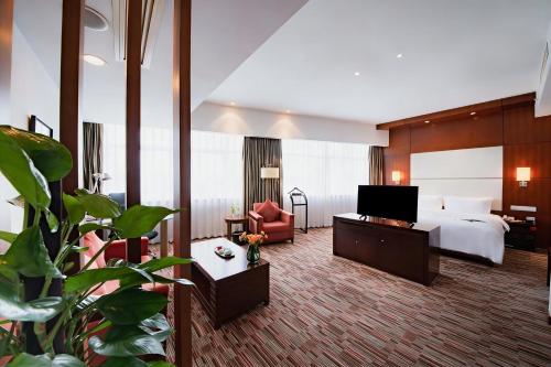 a hotel room with a bed and a television at Holiday Inn Xiaoshan by IHG in Hangzhou
