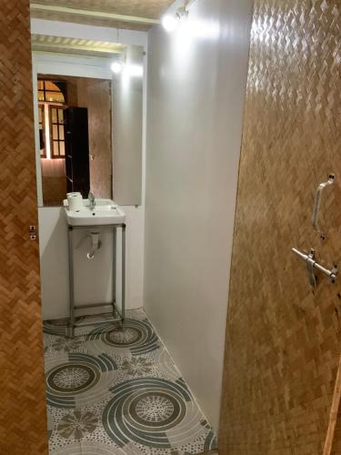 a bathroom with a sink and a mirror at Ruban Yoga in Palolem