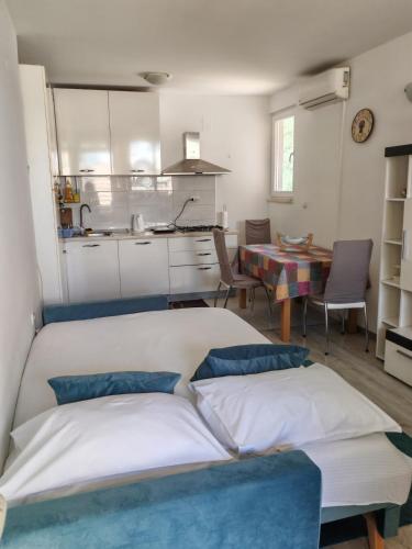 a living room with a bed and a kitchen at Guest House Oscar near the Sea and river in Mokošica