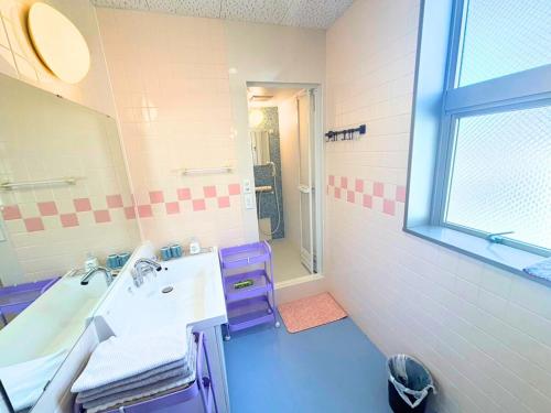 a bathroom with a sink and a mirror at Magokoro House 202 in Nishiizu