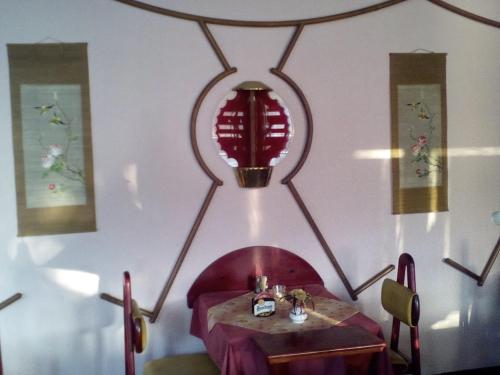 a dining room with a table and a red lamp at Penzion Velke Darko in Škrdlovice