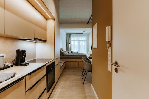 a small kitchen with a couch in the background at Quartier 90 in Wietmarschen