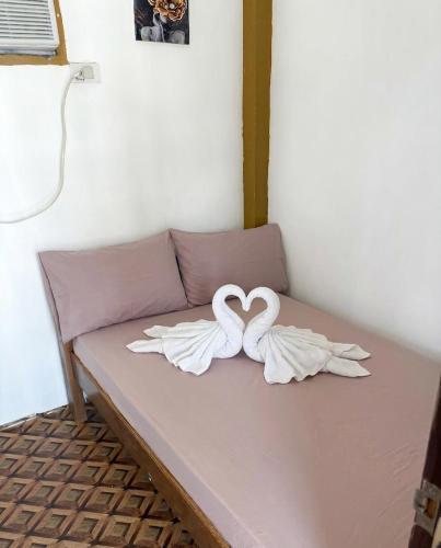 a couch with two swans forming a heart at Appleton Little Paradise Beach Resort & Restaurant REAL QUEZON in Real