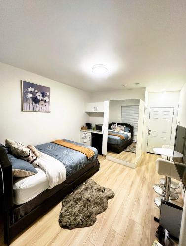 a bedroom with a bed and a desk in it at Quiet Private Room Victoria - PS5, Fast WiFi, Parking in Langford