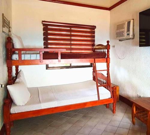 a couple of bunk beds in a room at Appleton Little Paradise Beach Resort & Restaurant REAL QUEZON in Real