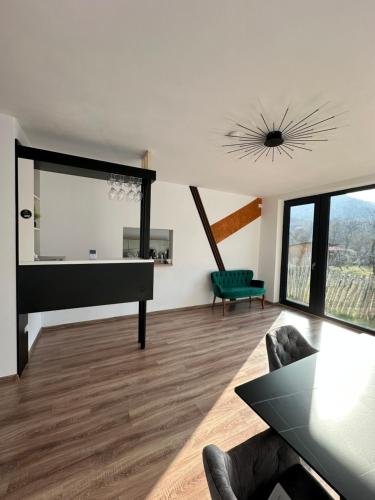 a living room with a piano and a table at Casa Montwis in Brezoi