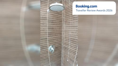 a shower with a glass door with a shower head at Asiago Millepini in Asiago