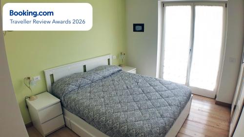 a bedroom with a bed with a gray comforter at Asiago Millepini in Asiago