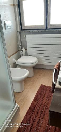 a bathroom with two toilets and a shower at I sogni di viola in Saluzzo