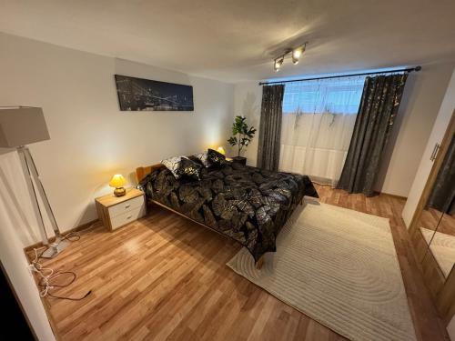 a large bedroom with a bed and a window at Apartment MBD in Veľká Mača