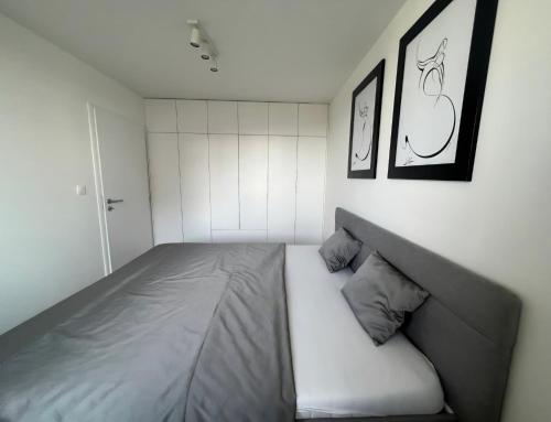 a bedroom with a bed and two pictures on the wall at Nová rezidencia, 7 minut pešo do centra in Košice