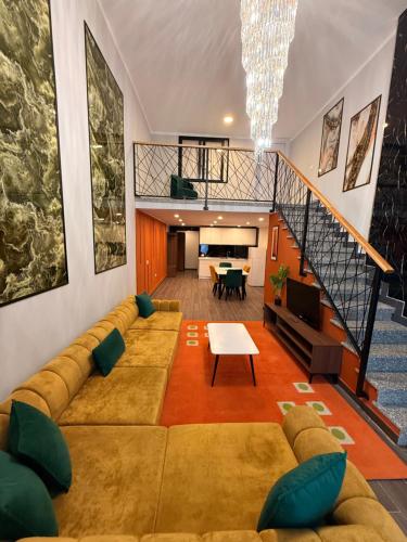 a living room with a couch and a table at Andor Luxury Hotel & Duplex in Durrës