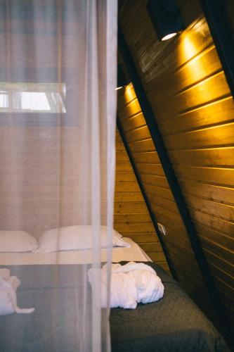 a bedroom with two beds and a window at Orange Cottage in Agara