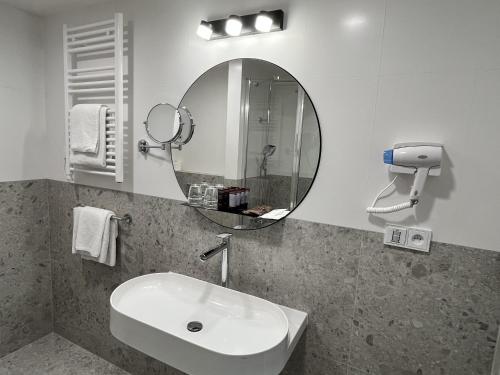 a bathroom with a sink and a mirror at Hotel ILF in Prague