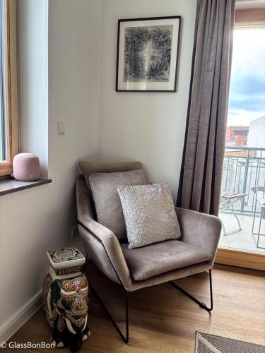 a chair sitting in a room with a window at Altstadtflair - Ruppin Quartier Stadtmitte in Neuruppin