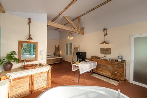 a large room with a bathroom with a sink at Êlim House in Phú Quốc