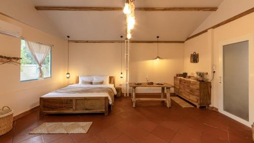 a bedroom with a bed and a table in it at Êlim House in Phú Quốc