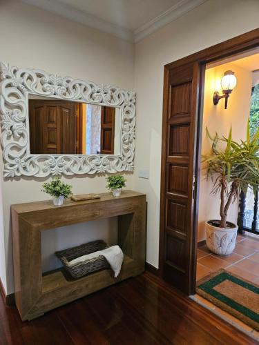 a living room with a fireplace and a mirror at Casa Villadam in Ribadesella