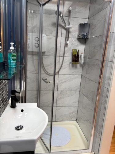 a bathroom with a shower and a sink at Tess's Guest House R95K6N1 This Property is unsuitable for children under 12 years old in Freshford