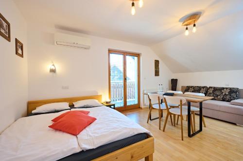 a bedroom with a bed and a table and a couch at Guesthouse S in Luče