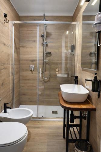 a bathroom with two sinks and a shower at BEDS&ROOMS TIBURTINA - Beds, Posti letto in Rome