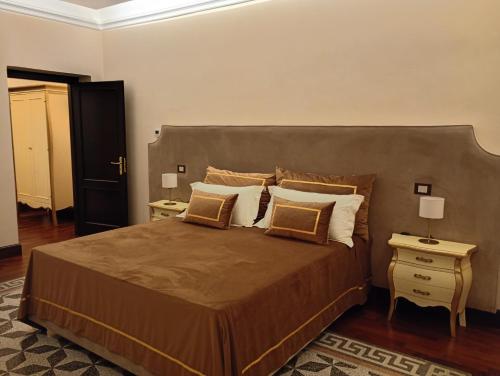 a bedroom with a large bed with two night stands at Villa Alliata Relais & Spa in Palermo