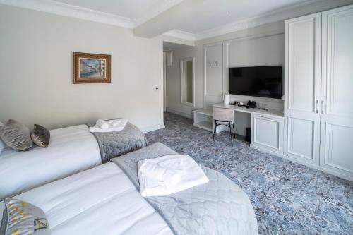 a hotel room with two beds and a television at VIZUALIZA Residence Hotel by HMG in Plovdiv