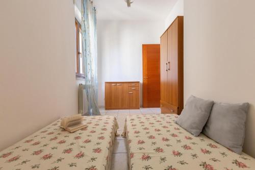 a bedroom with a bed with a blanket on it at Borgagne Apartment by BarbarHouse in Borgagne