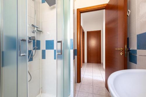 a bathroom with a shower and a sink at Borgagne Apartment by BarbarHouse in Borgagne