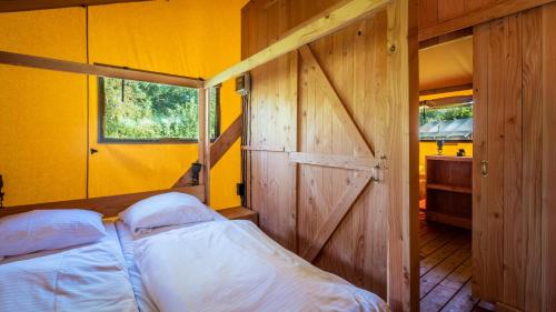 a bedroom with a door and a bed in a room at Papillon Country Resort in Denekamp