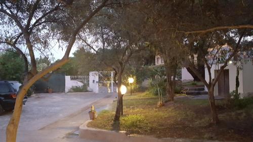 a street with a fire hydrant in a yard with trees at Borgo degli Ulivi Depandance in Capoterra
